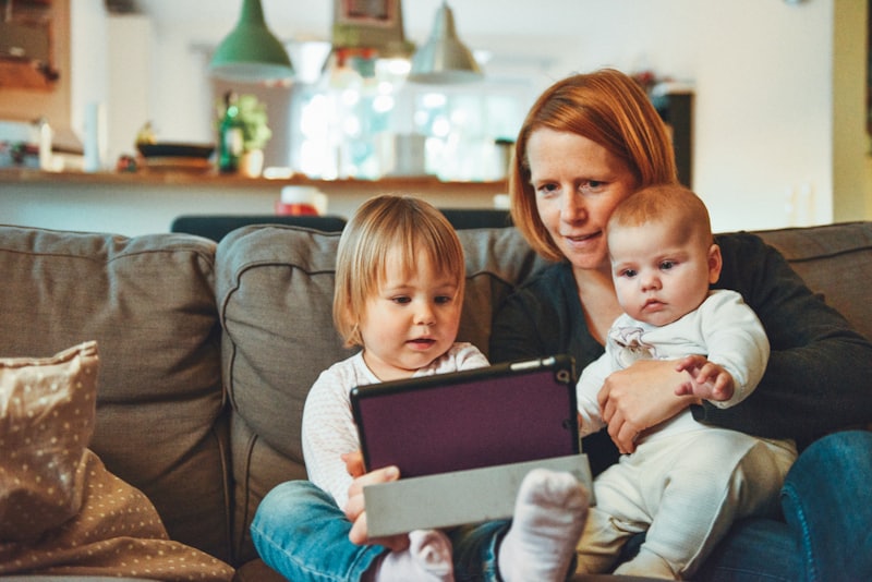 A parent and toddler sitting together at home